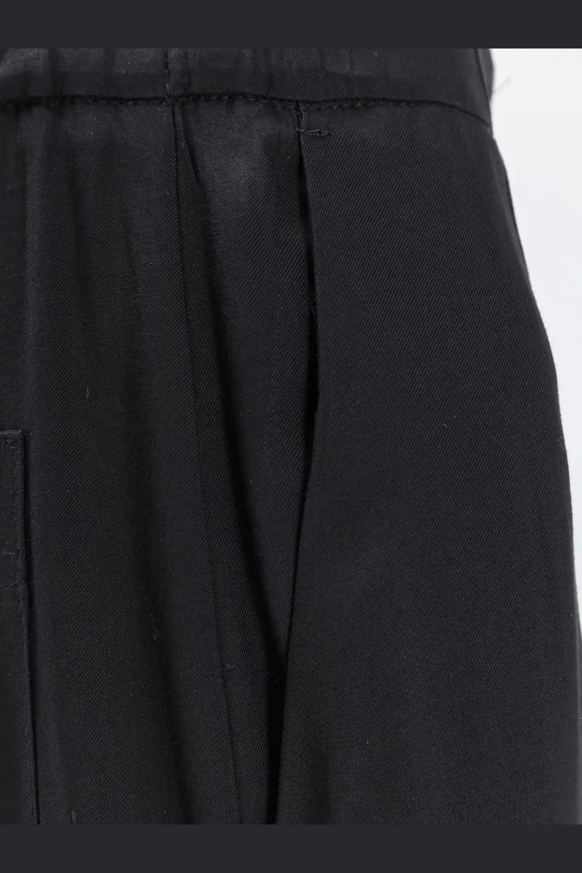 Black pleated viscose trousers for women with a structured waistband and subtle texture from nude collection