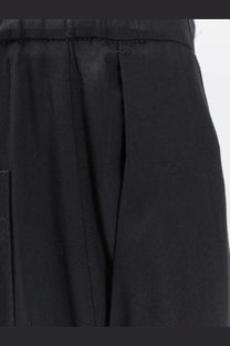 Black pleated viscose trousers for women with a structured waistband and subtle texture from nude collection