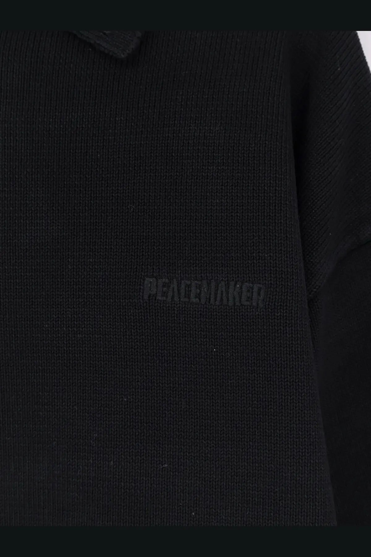 Oamc Peacemaker men’s black cotton knitted polo shirt with subtle peacewaker embroidery on the chest