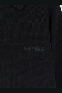Oamc Peacemaker men’s black cotton knitted polo shirt with subtle peacewaker embroidery on the chest
