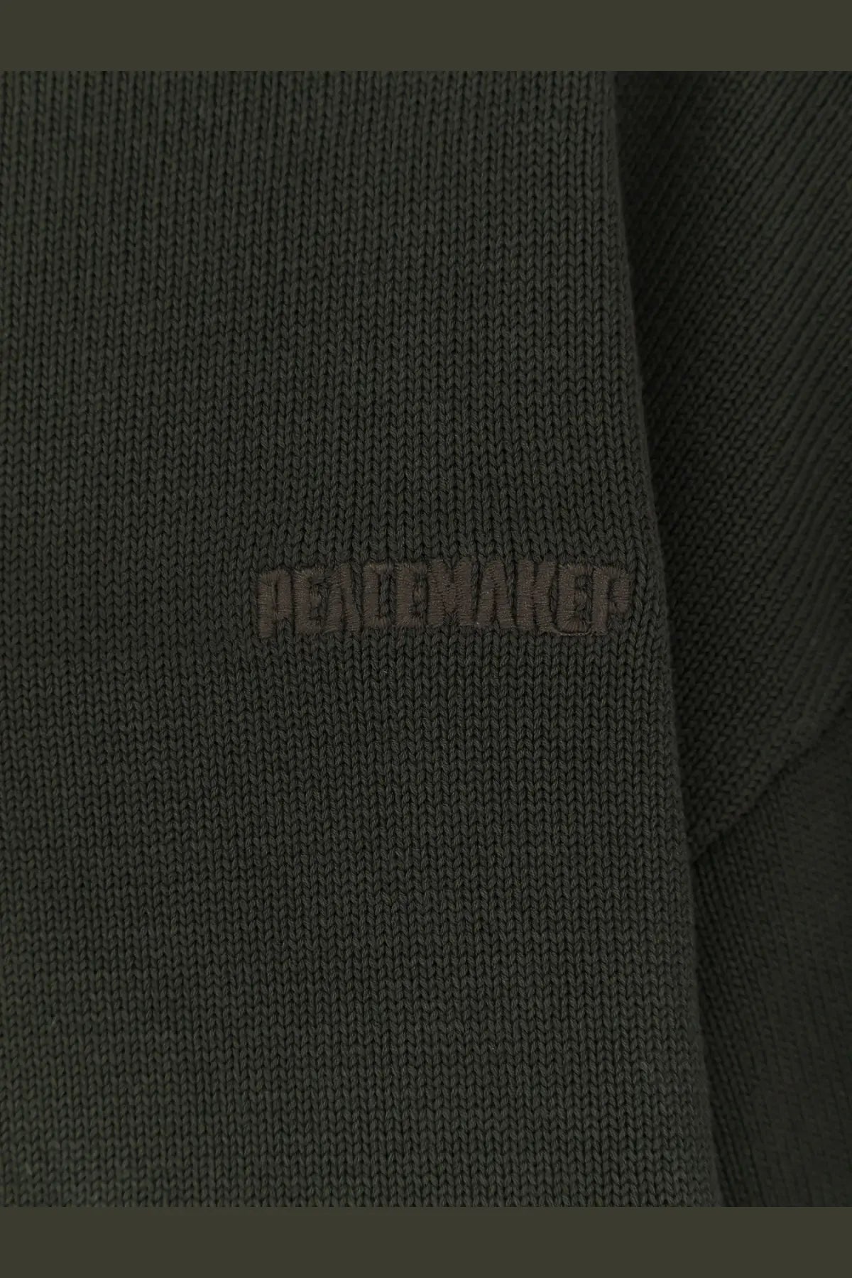Dark olive green knitted cotton sweater with peacemaker embroidery in matching thread from oamc men’s collection