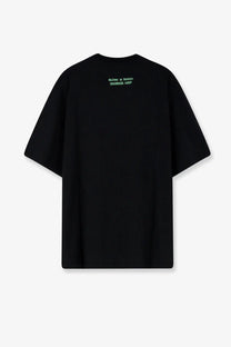 Black oversized oamc peacemaker men’s cotton t-shirt with subtle green text print at the neckline
