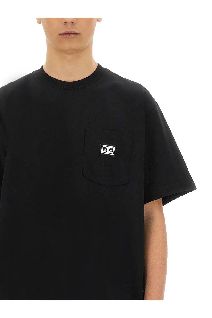 Obey men’s black short-sleeved t-shirt with chest pocket and white rectangular logo patch on the front