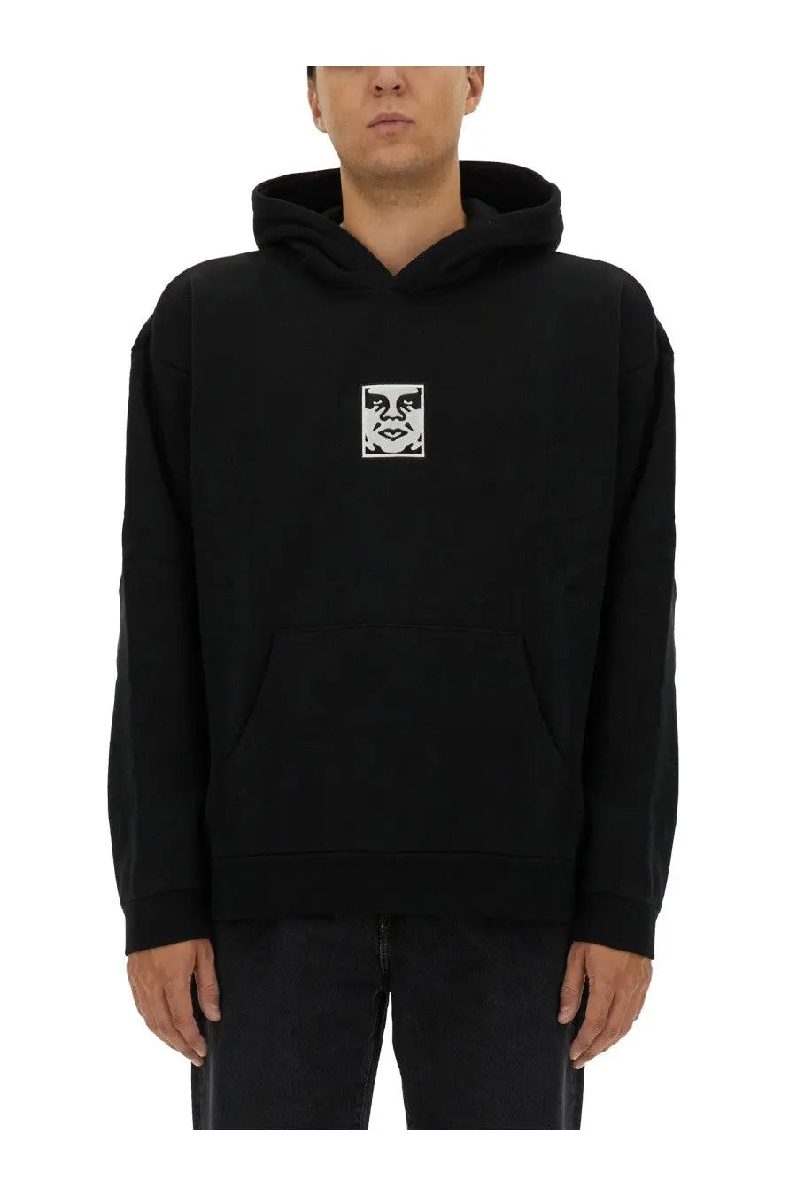 Obey men’s black hoodie featuring a white eye and mouth graphic on the chest in comfortable cotton material