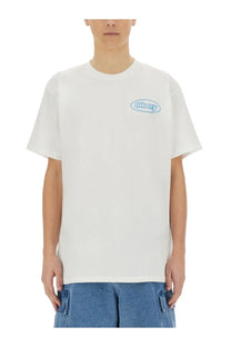 Obey men’s white cotton reaction shirt with light blue embroidered obey logo oval on left chest