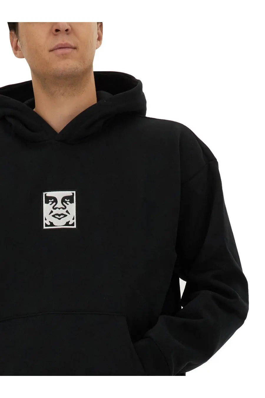 Obey men’s black hoodie with white embroidered face logo on chest made of comfortable sweatshirt material