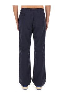 Back side of palm angels men’s dark navy blue wide-leg trousers with relaxed fit and buttoned back pockets