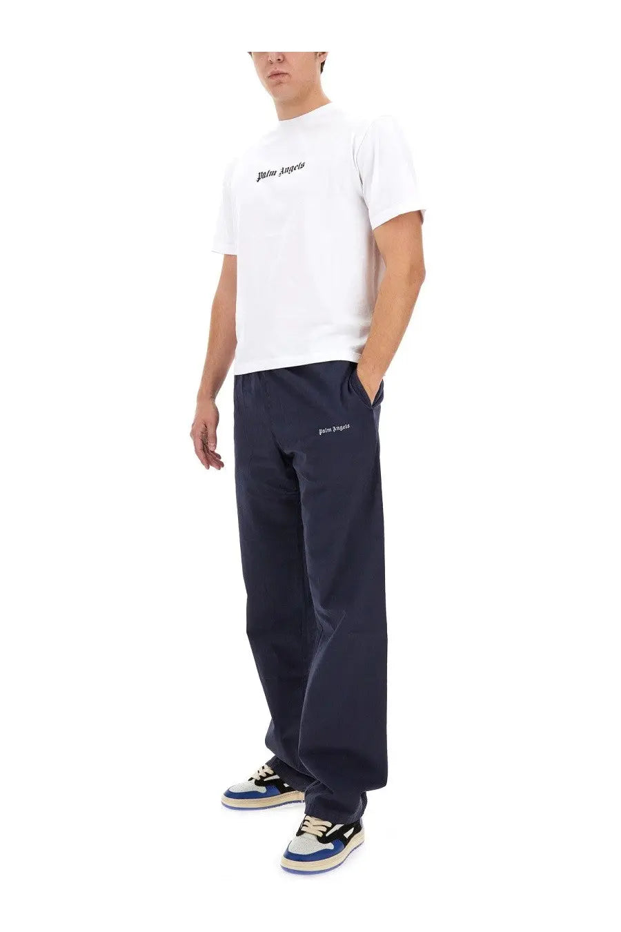 White palm angels t-shirt with black logo paired with palm angels men’s blue pants in casual style