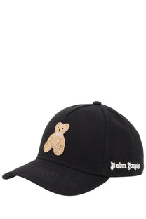 Palm Angels women’s black baseball cap featuring a beige embroidered teddy bear and white script branding