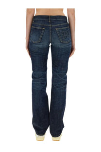 Back view of palm angels women’s dark blue denim straight leg jeans with embroidered logo on the pocket