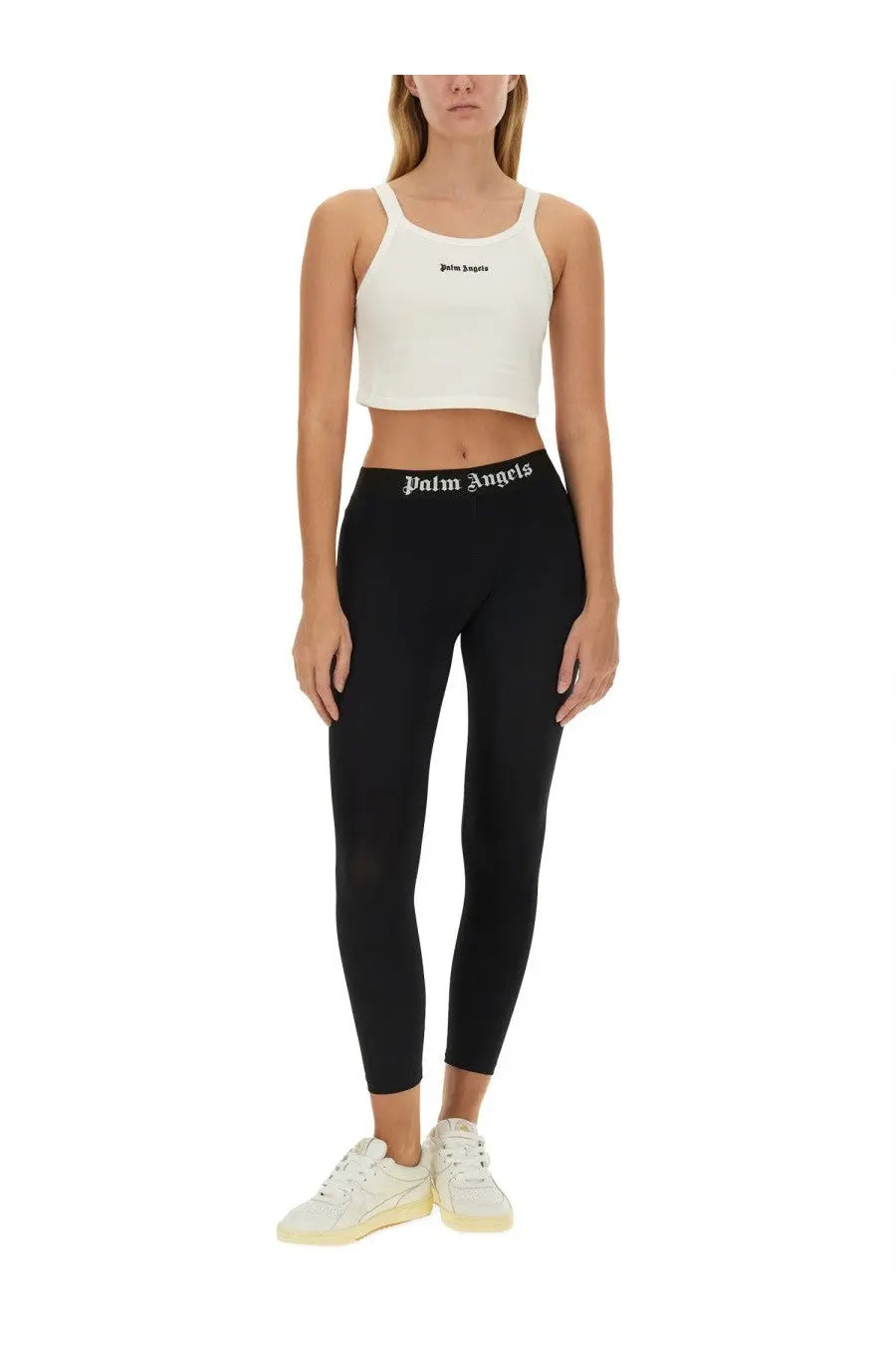 Black leggings with white palm angels logo on waistband paired with palm angels women’s white tank top