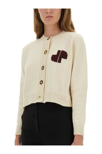 Patou women’s beige knit cardigan with cream color, dark brown embroidered logo, and gold-toned buttons on chest