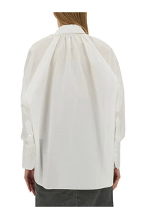 Patou women’s white cotton blouse with oversized button-down design and subtle pleats at the back visible