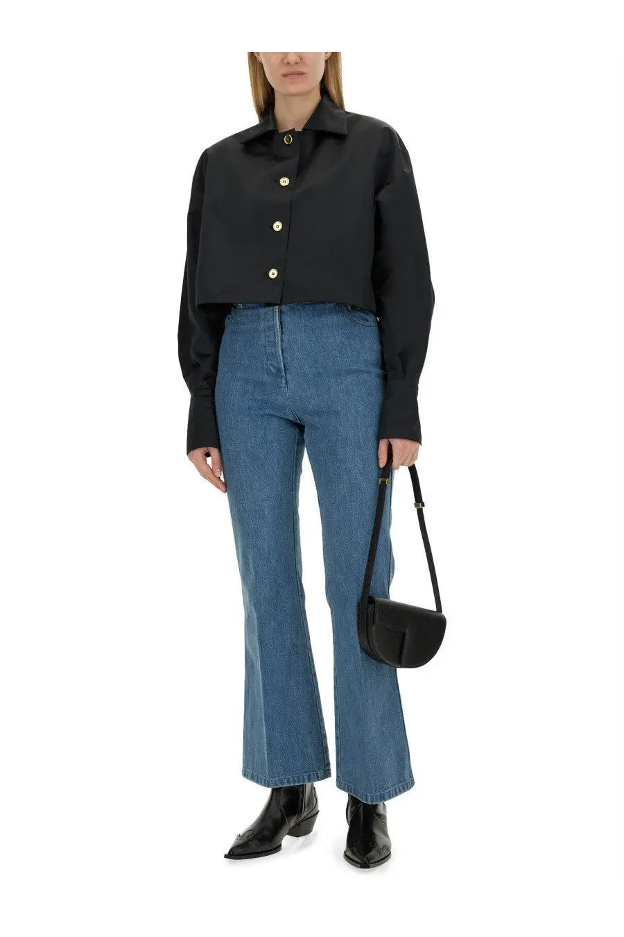 Black leather crossbody bag with minimalist design and gold-tone hardware paired with patou women’s flare fit jeans blue
