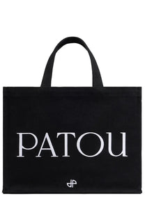 Black canvas Patou women’s medium tote bag with white embroidered lettering and small logo at the bottom