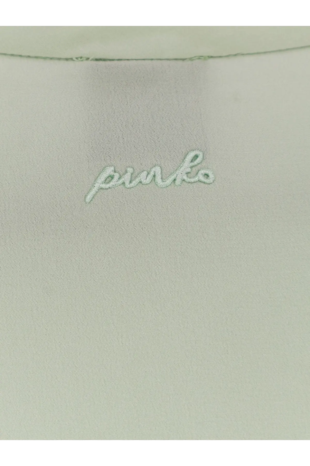 Light green satin fabric with pinko embroidered in matching thread on the pinko women’s blossom silk shirt green