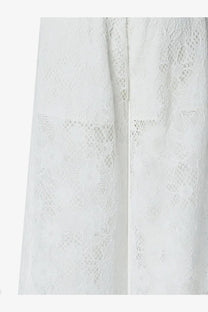 White lace fabric with delicate intricate pattern on pinko women’s laurie lace trousers white