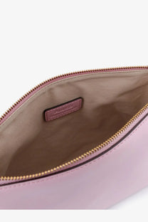 A soft pink leather Pinko women’s beauty case clutch with a gold-toned zipper and matching brand tag inside