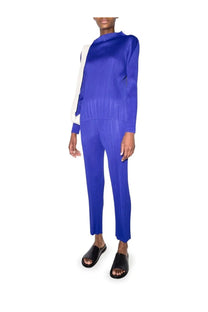 Vibrant royal blue pleated knit jumpsuit with high neckline and long sleeves from pleats please issey miyake