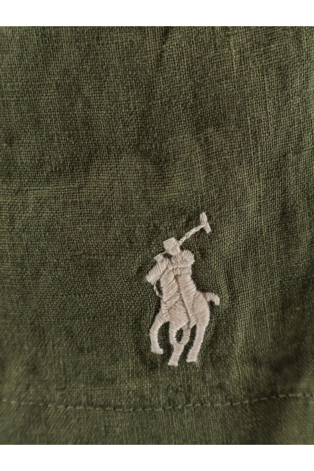 Olive green cotton cap with white embroidered polo ralph lauren logo paired with men’s linen bermuda shorts garden trail