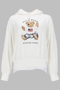 White hooded sweatshirt featuring a cartoon bear with american flag shirt and blue jeans by ralph lauren