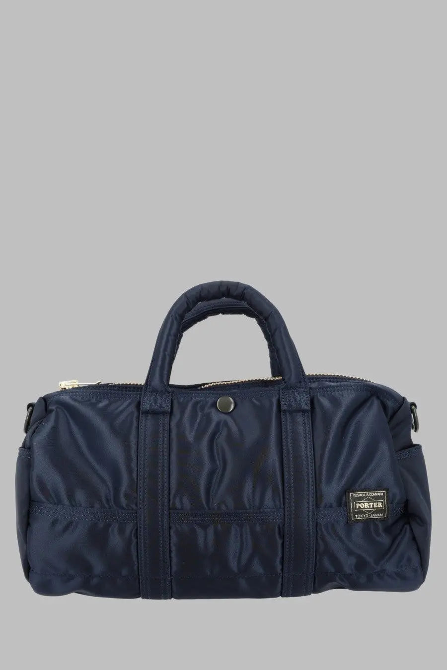 Navy blue nylon porter duffel bag with reinforced stitching and front pocket by porter yoshida and co