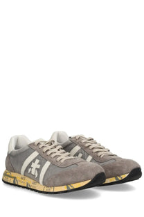 Premiata men’s sneaker Lucy grey featuring gray suede, white stripes, and a yellow graphic design on the sole