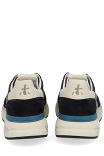 Back view of premiata men’s sneaker mick blue in black and cream suede with bold blue midsole and premiata logo on heel