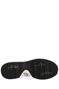 Black rubber sole with gold lettering and white triangular logo patch on the back of premiata men’s sneaker mick blue