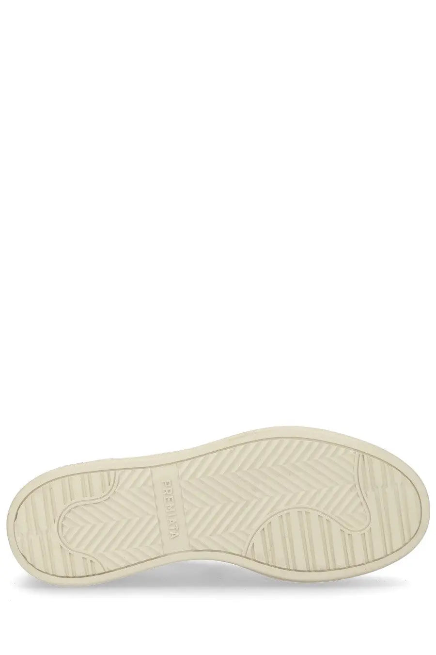 Cream-colored rubber sole with herringbone tread and komono branding on the premia women’s micol sneaker white back side