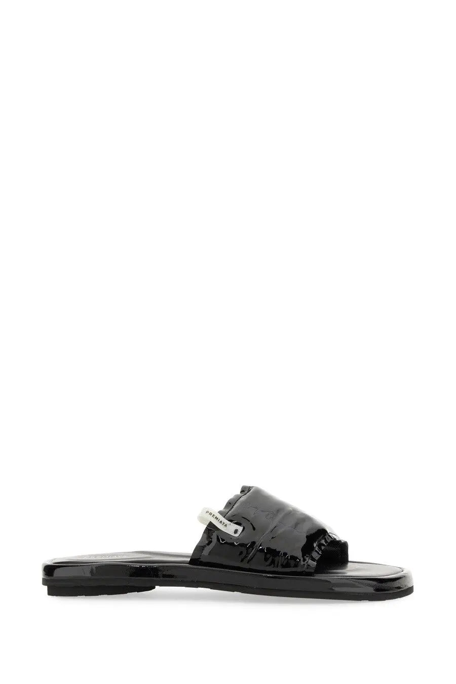 Black patent leather slide sandal with white label featuring Premiata brand name for women