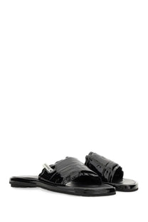 Premiata women’s slide sandal in black patent leather with a sleek minimalist design and small brand tag on the strap