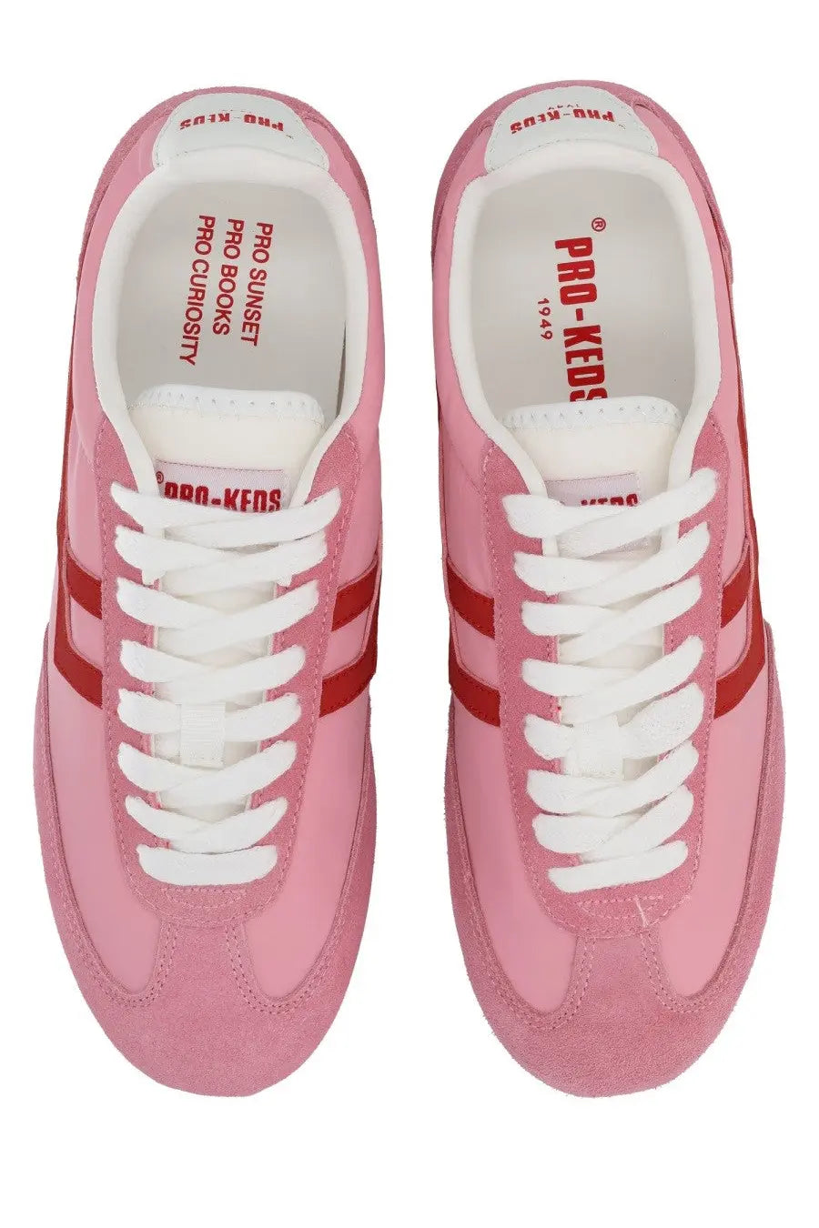 Pink suede pro-keds women’s sneaker with red stripes and white laces in the pro-keds women’s reacer sneaker blue product line
