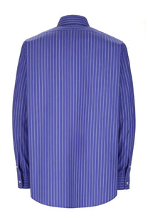 A royal blue long-sleeved no problemo men’s camicia con blue dress shirt with fine white pinstripes and a classic collar