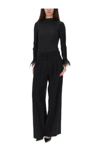 Black pt torino womens pants frankie with wide-leg design paired with a black high-neck knit top with feathered cuffs