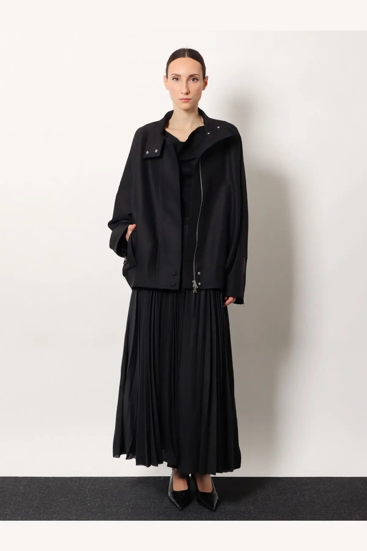 R2W women’s Arissto black pleated midi skirt with smooth flowing silhouette and subtle vertical folds
