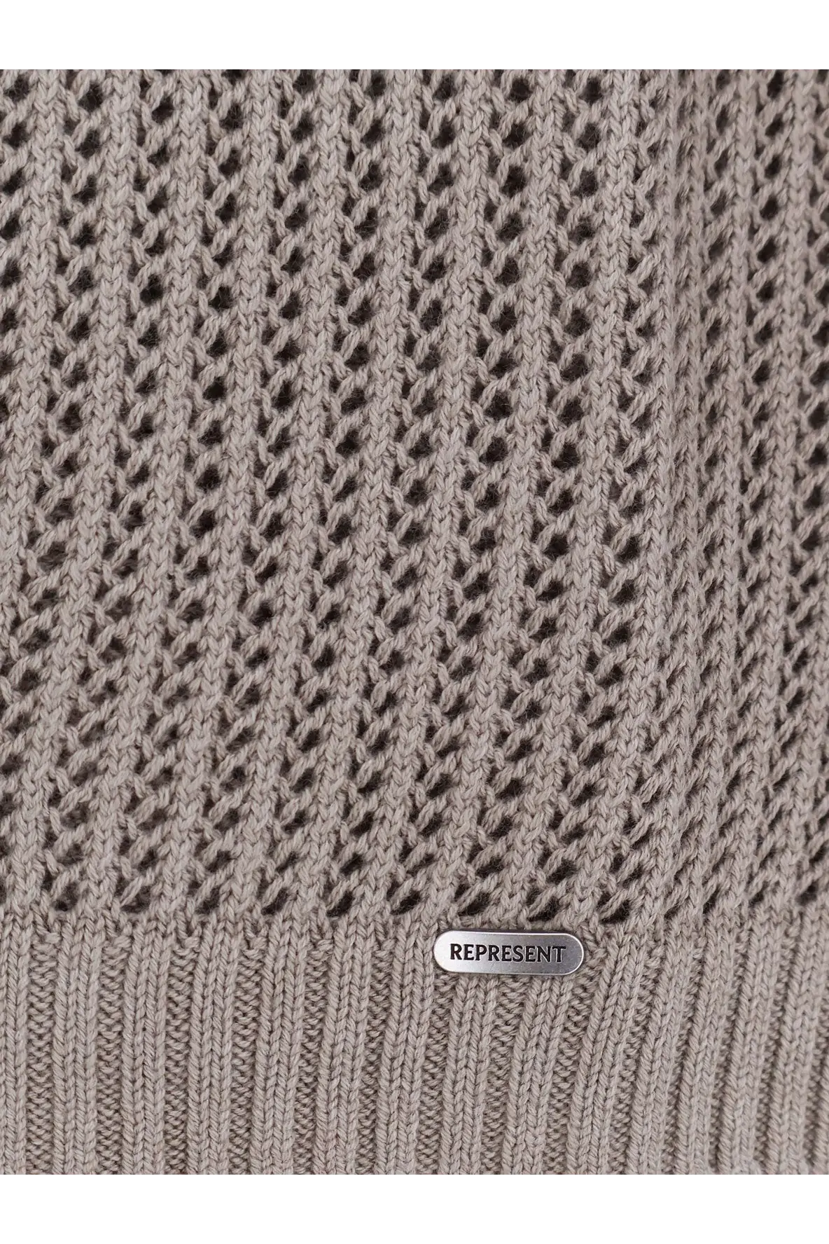 A taupe knitted sweater with textured openwork pattern and ribbed hem with silver represent brand tag