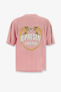 Represent men’s cotton shirt beige featuring a soft pink oversized design with golden winged figures and white represent text