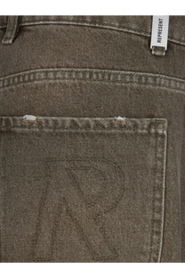 Back side of dark gray denim represent men’s jeans with subtle embroidered r on pocket and white represent brand tag