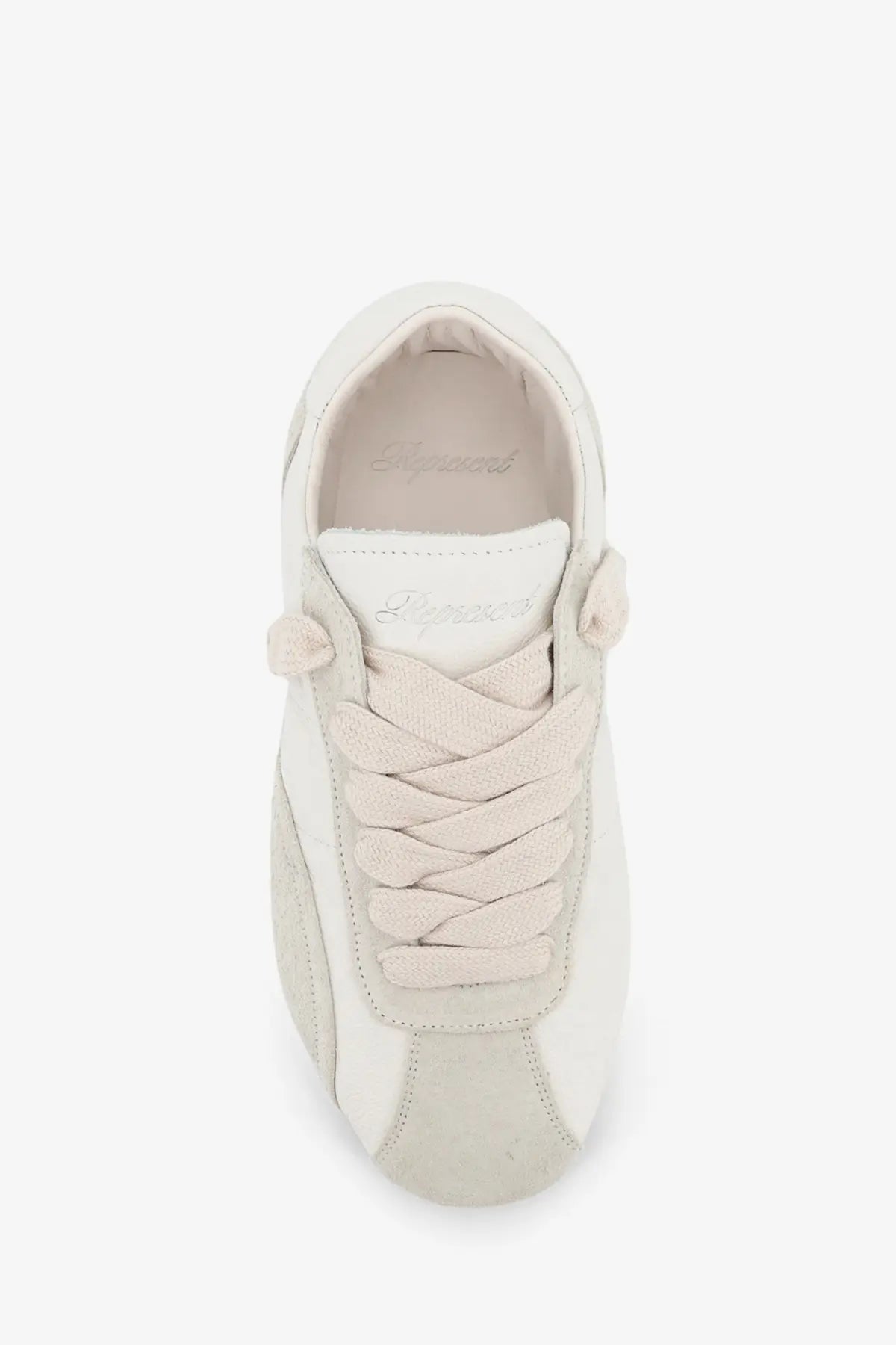 Cream-colored represent men’s leather and suede sneaker with braided laces and a minimalist design