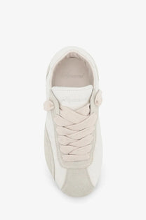 Cream-colored represent men’s leather and suede sneaker with braided laces and a minimalist design