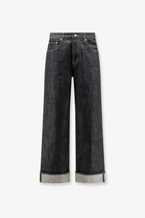 Represent men’s selvedge denim shirt black paired with dark-wash straight-leg jeans with rolled cuffs showing lighter fabric