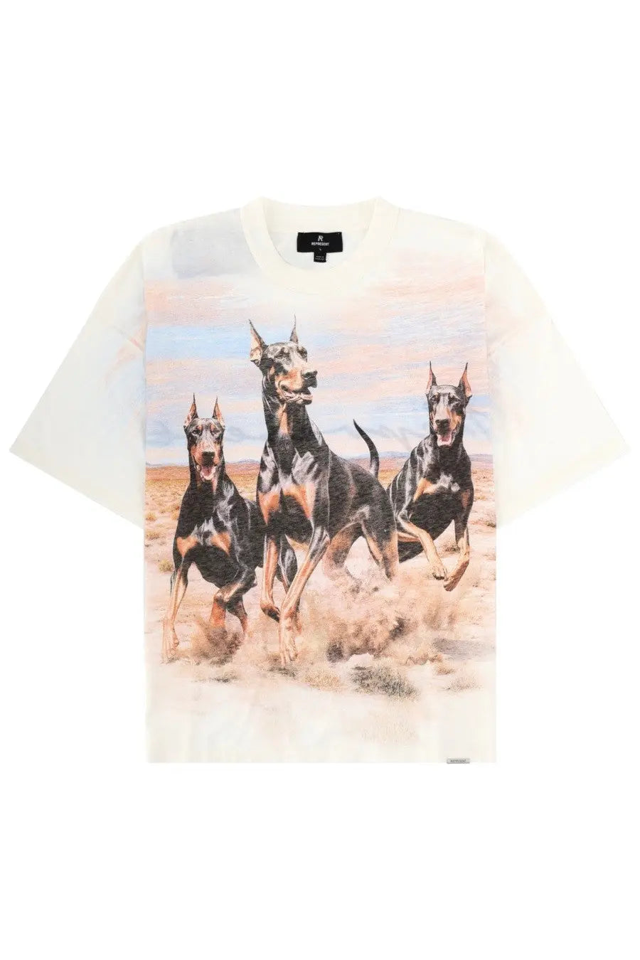 Off-white short-sleeved cotton t-shirt featuring a graphic print of three running Doberman pinschers in a desert