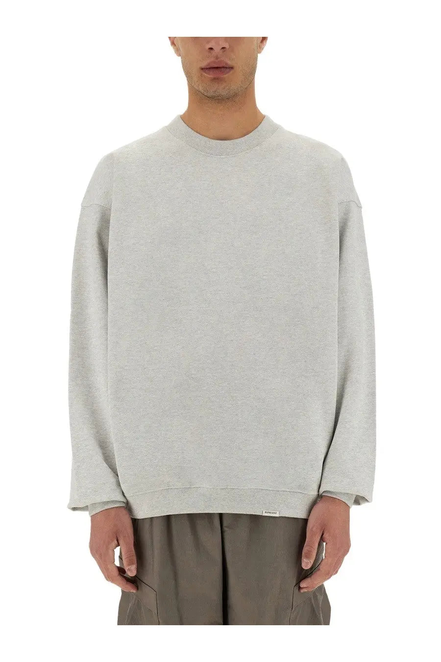 A light gray oversized crewneck sweatshirt by represent men with soft cotton texture and subtle ribbed cuffs