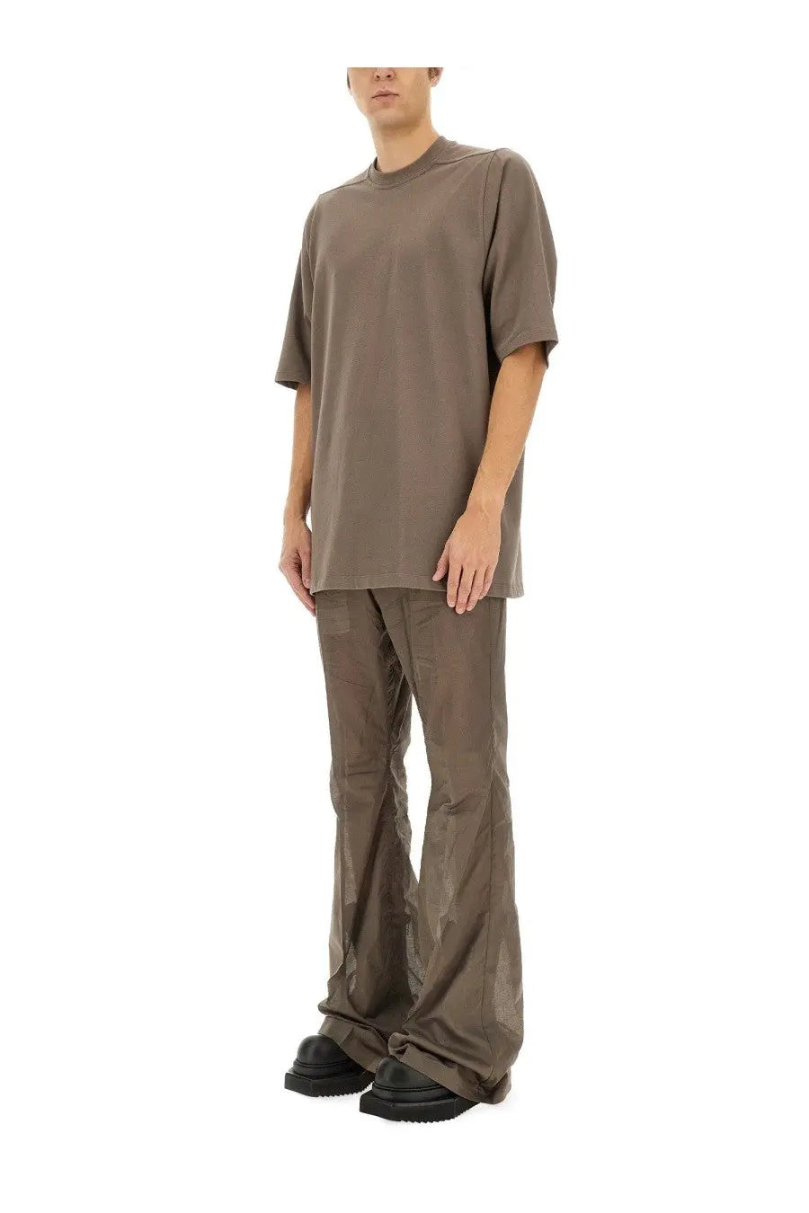 Minimalist olive green oversized t-shirt with relaxed fit and short sleeves paired with rick owens grey bootcut pants