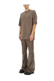 Minimalist olive green oversized t-shirt with relaxed fit and short sleeves paired with rick owens grey bootcut pants