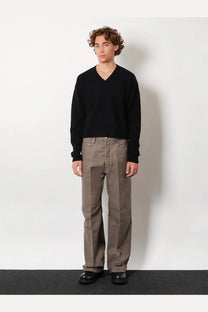 Black v-neck knit sweater paired with rick owens men’s geth certified grey cotton trousers in front view