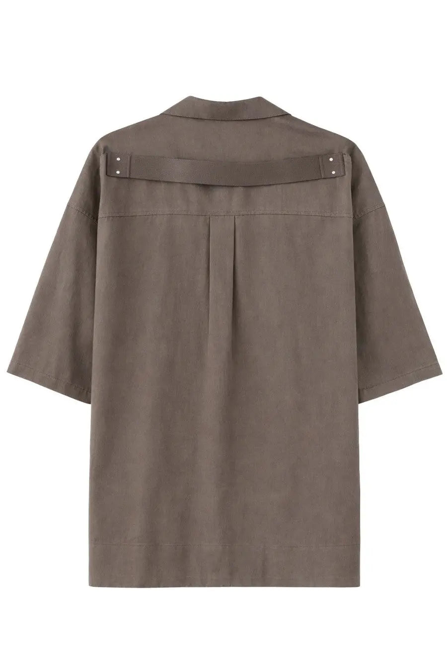Back view of a taupe-colored rick owens men’s magnum tommy short sleeve shirt with structured collar and horizontal strap detail