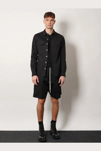 Black long-sleeved button-up Rick Owens shirt with two chest pockets and central zipper detail in organic cotton