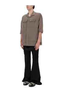 A muted gray oversized short-sleeved shirt with chest pockets paired with black rick owens mens megastrapped bolans pants